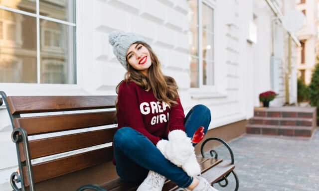 full-length-beautiful-young-girl-with-long-hair-knitted-hat-jeans-white-gloves-sitting-bench-street.jpeg